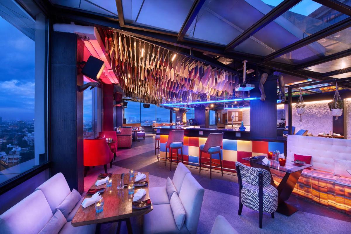 a restaurant with tables and chairs and a bar at The Accord Metropolitan in Chennai