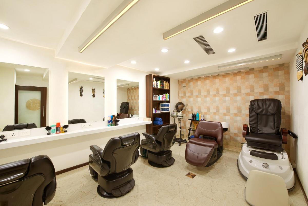a hair salon with chairs and a mirror at The Accord Metropolitan in Chennai
