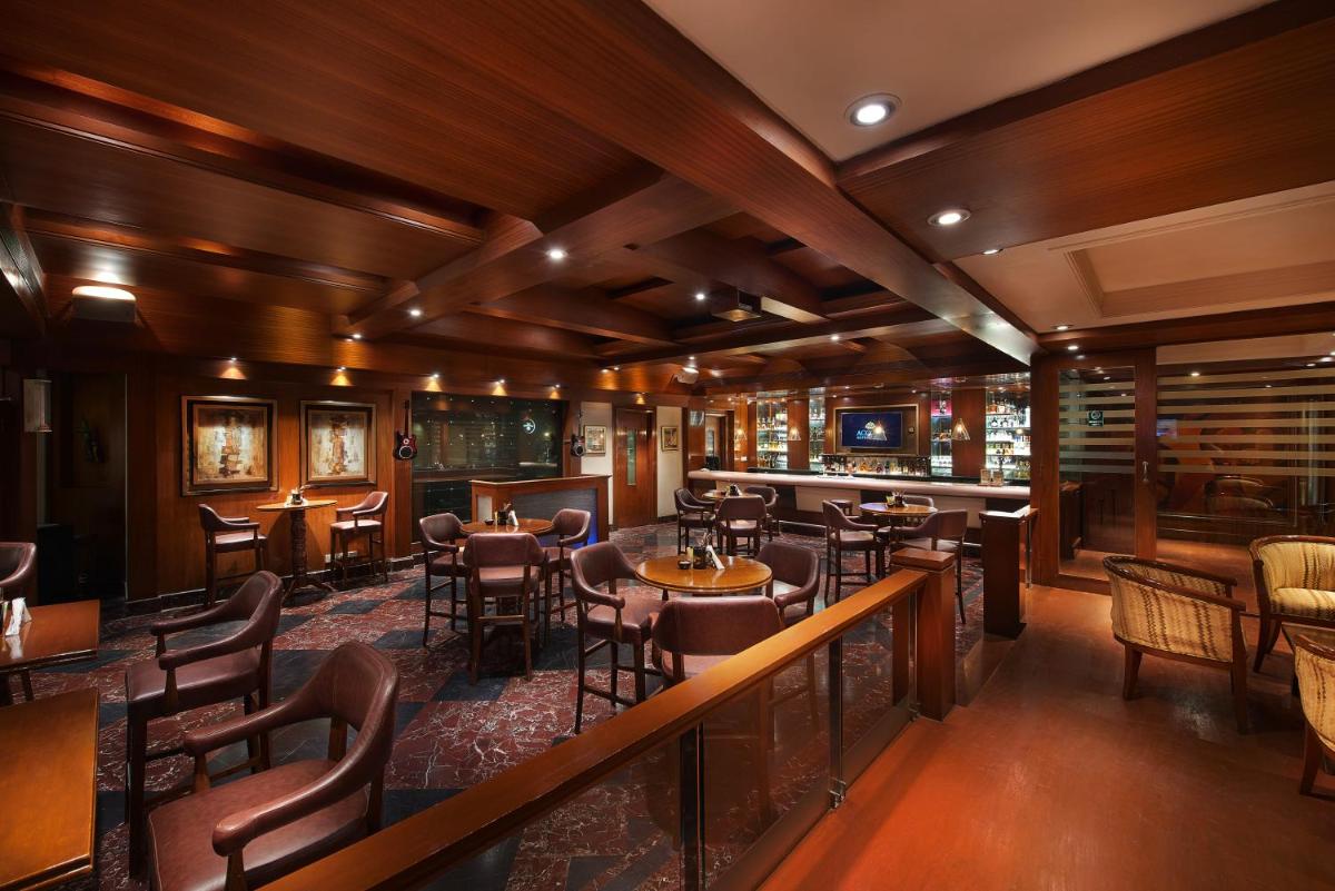 a restaurant with tables and chairs and a bar at The Accord Metropolitan in Chennai
