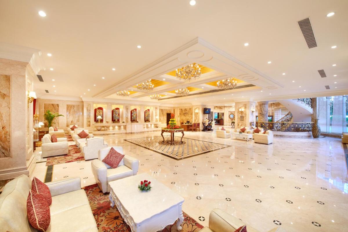 a large living room with white furniture and a large ceiling at The Accord Metropolitan in Chennai