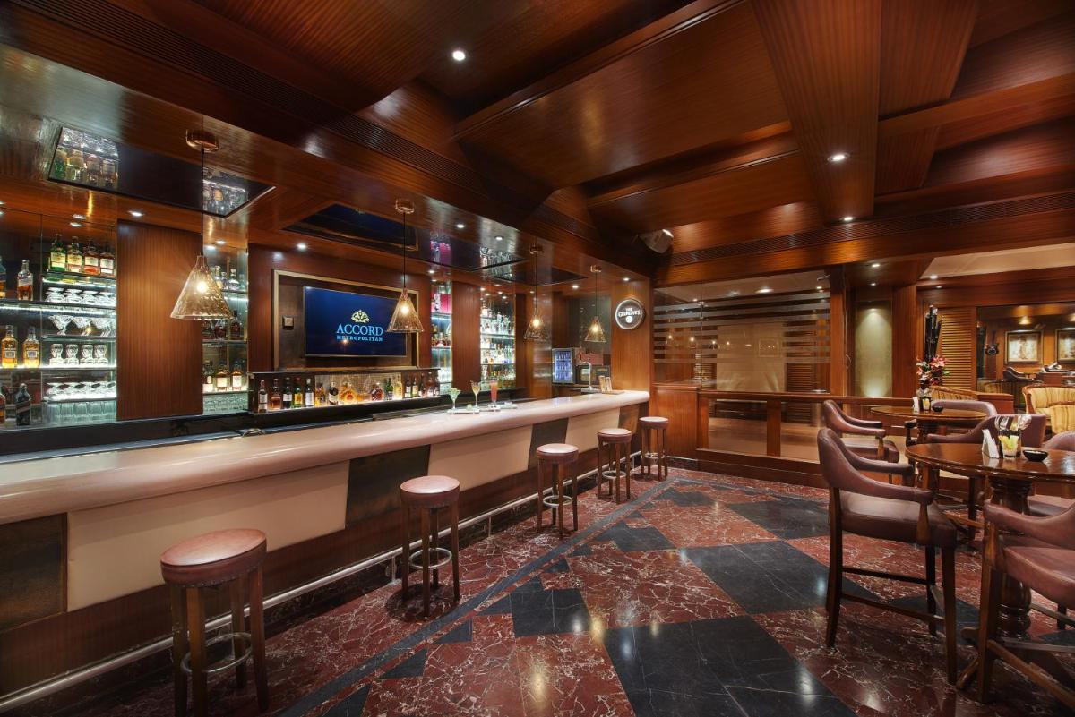 a bar in a restaurant with wooden ceilings at The Accord Metropolitan in Chennai