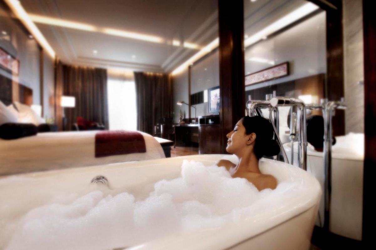 a woman sitting in a bathtub filled with clouds at Crowne Plaza Today Gurugram by IHG in Gurgaon
