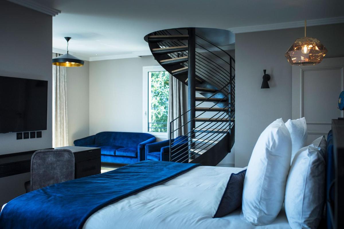 Un ou plusieurs lits dans un hébergement de l'établissement Hôtel L'Incomparable Aix-Les-Bains