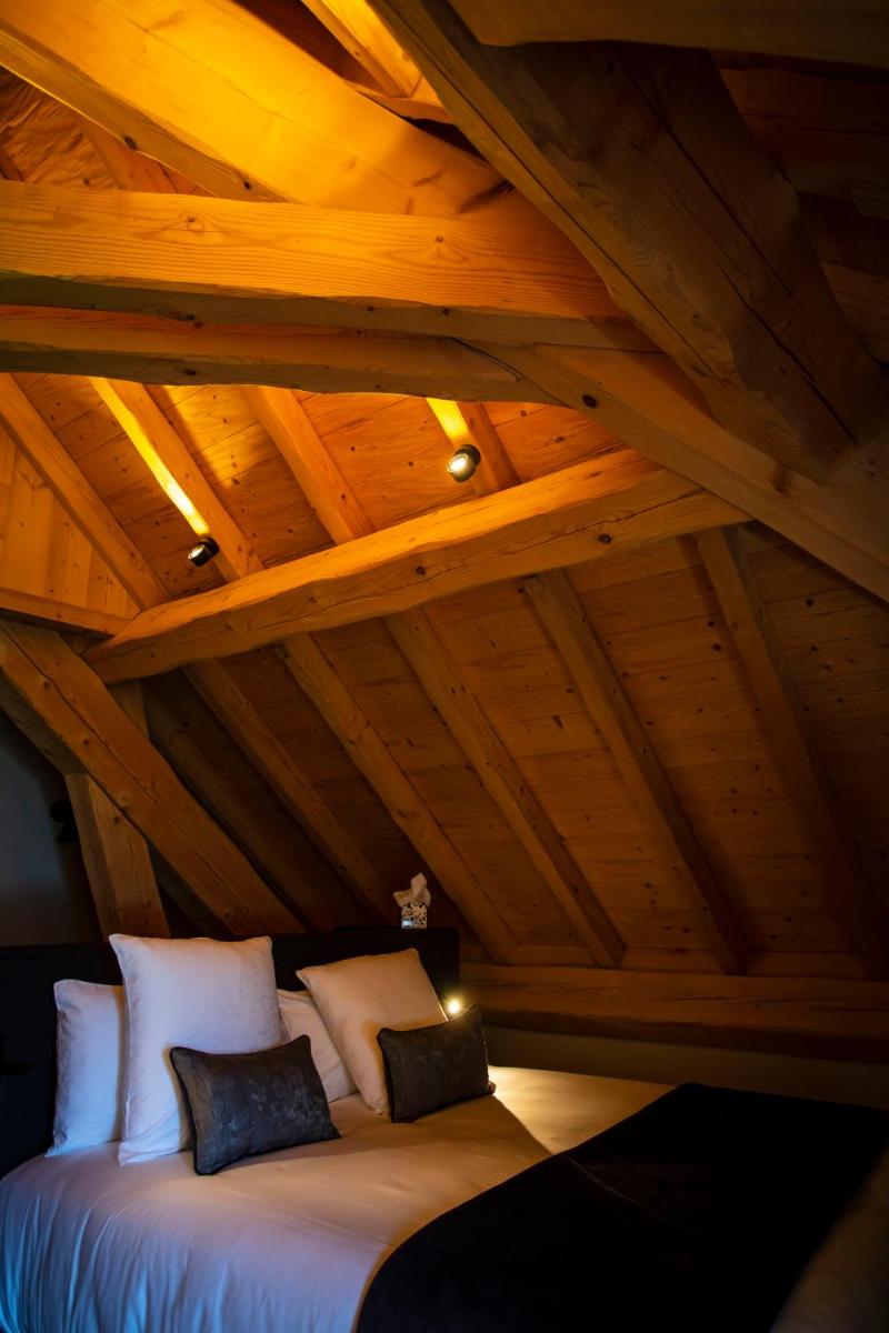 Un ou plusieurs lits dans un hébergement de l'établissement Hôtel L'Incomparable Aix-Les-Bains