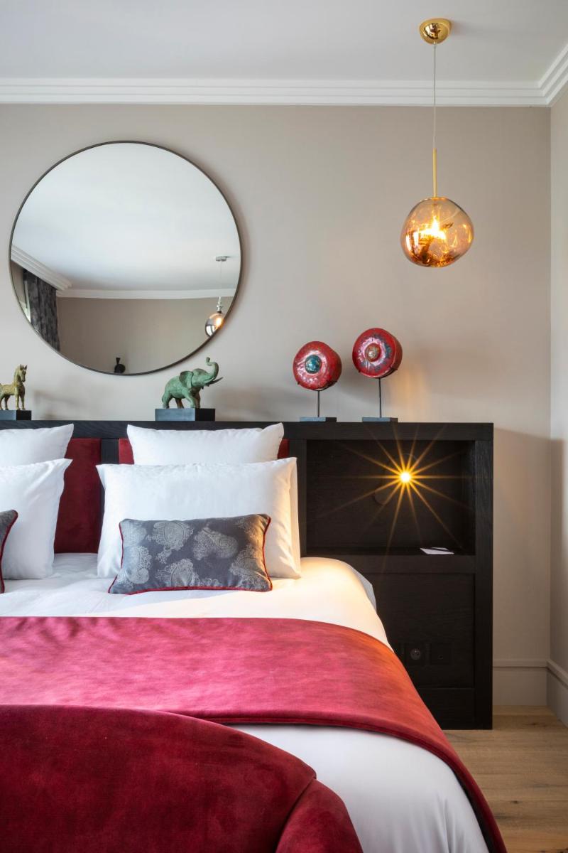 Un ou plusieurs lits dans un hébergement de l'établissement Hôtel L'Incomparable Aix-Les-Bains