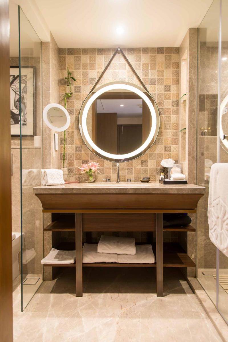 a bathroom with a large sink and a mirror at Taj Bengal in Kolkata