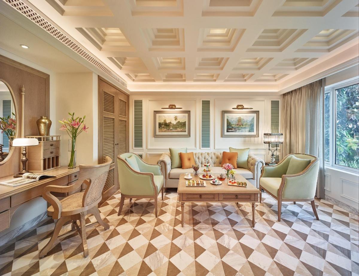 a living room with a couch and chairs and a table at Taj Bengal in Kolkata