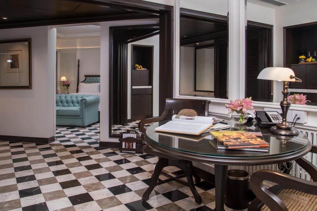 a living room with a table and a couch at Taj Bengal in Kolkata