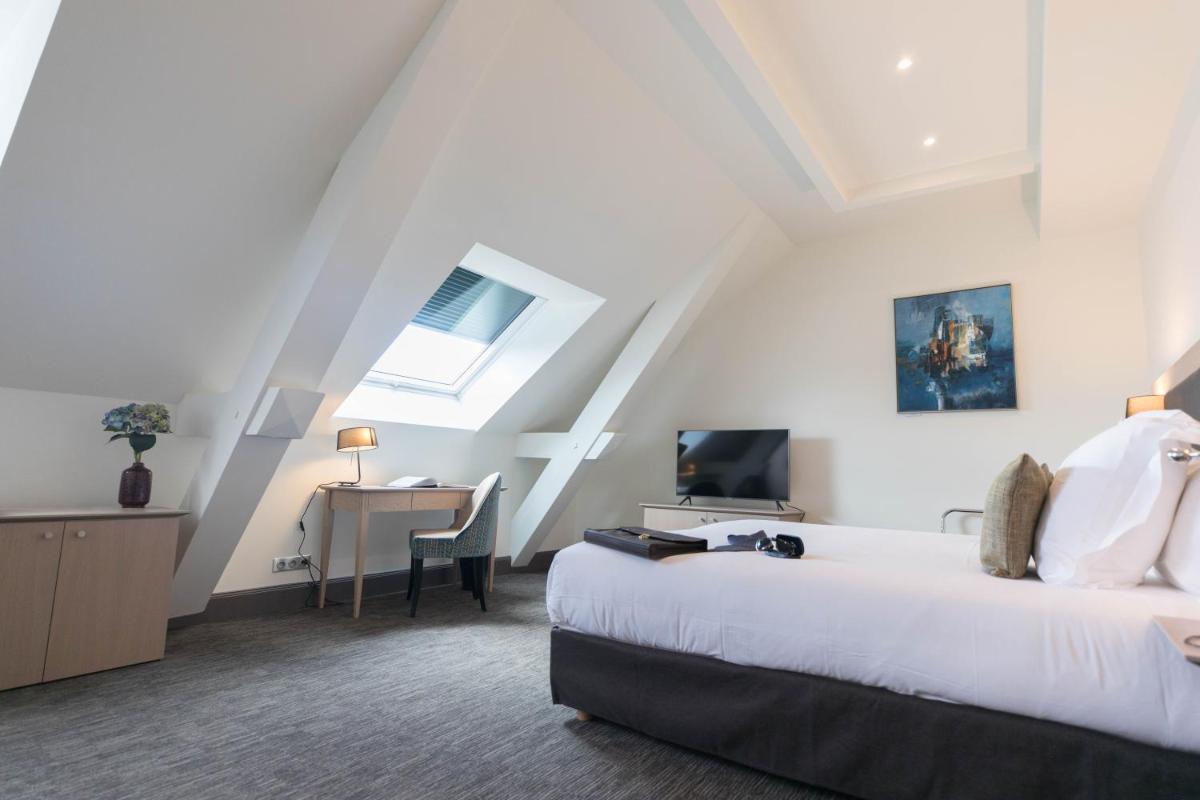 Un ou plusieurs lits dans un hébergement de l'établissement Hôtel Spa Marotte