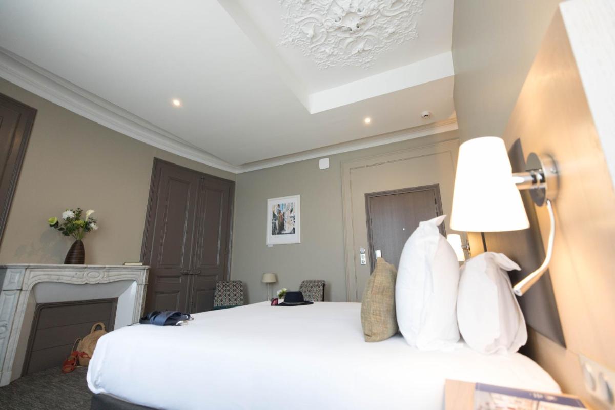 Un ou plusieurs lits dans un hébergement de l'établissement Hôtel Spa Marotte