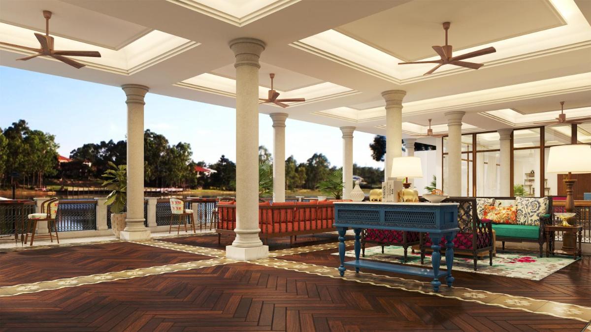 an outdoor deck with a blue piano on a patio at Pilibhit House, Haridwar – IHCL SeleQtions in Haridwār