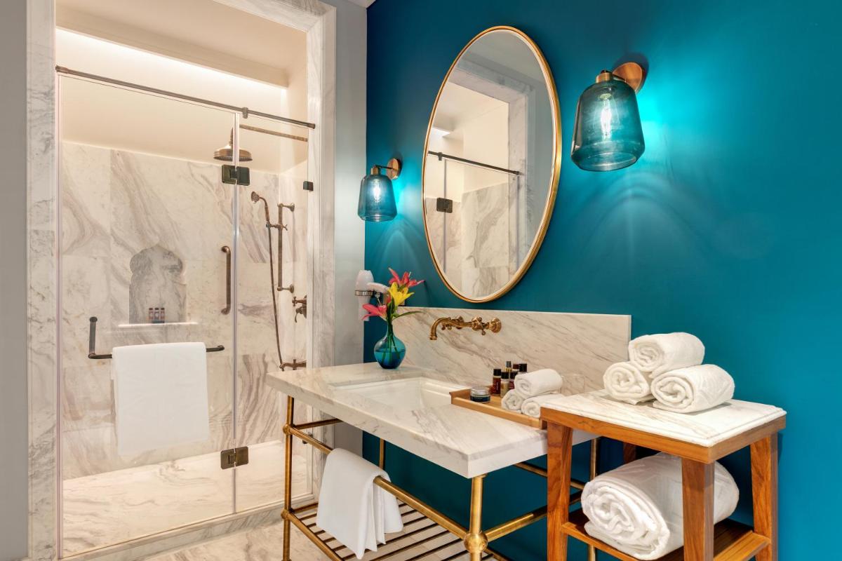 a bathroom with a sink and a mirror at Pilibhit House, Haridwar – IHCL SeleQtions in Haridwār a bathroom with a sink and a mirror at Pilibhit House, Haridwar – IHCL SeleQtions in Haridwār