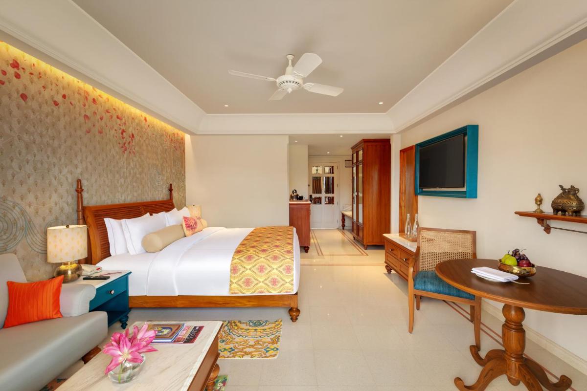 a bedroom with a bed and a living room at Pilibhit House, Haridwar – IHCL SeleQtions in Haridwār