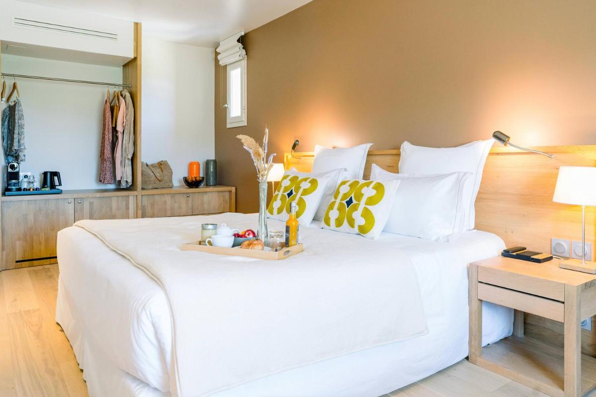 Un ou plusieurs lits dans un hébergement de l'établissement Château L'Hospitalet Wine Resort Beach & Spa