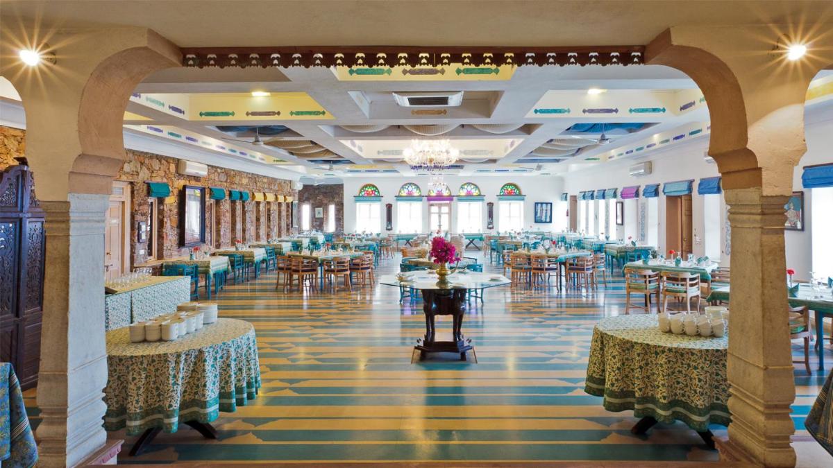 a large banquet hall with tables and chairs at Neemrana Fort-Palace in Neemrana