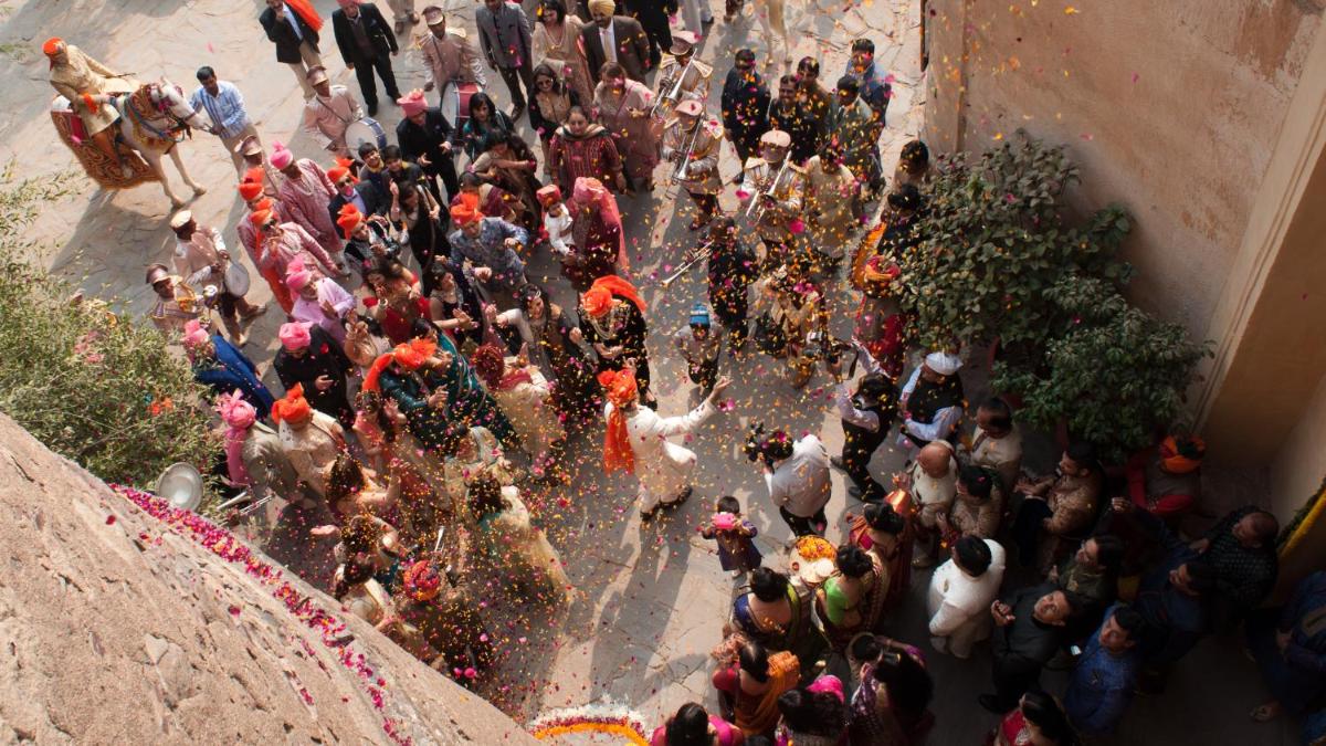 a large group of people playing in a fountain at Neemrana Fort-Palace in Neemrana