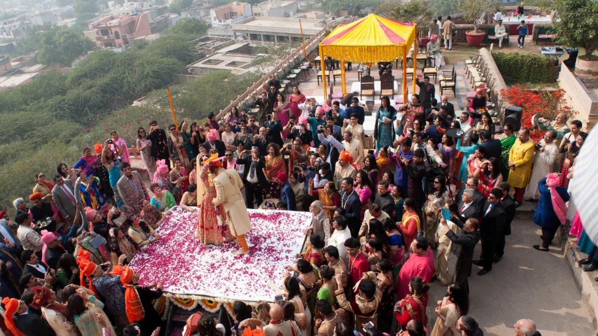 a large crowd of people standing around a ceremony at Neemrana Fort-Palace in Neemrana