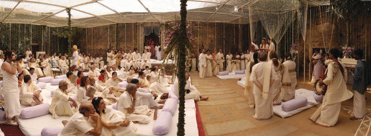 a large room filled with people sitting on beds at Neemrana Fort-Palace in Neemrana