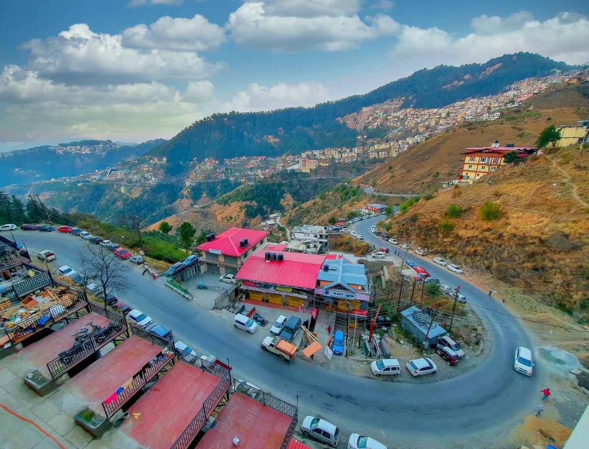 an aerial view of a town on a mountain at The Orchid Shimla in Shimla