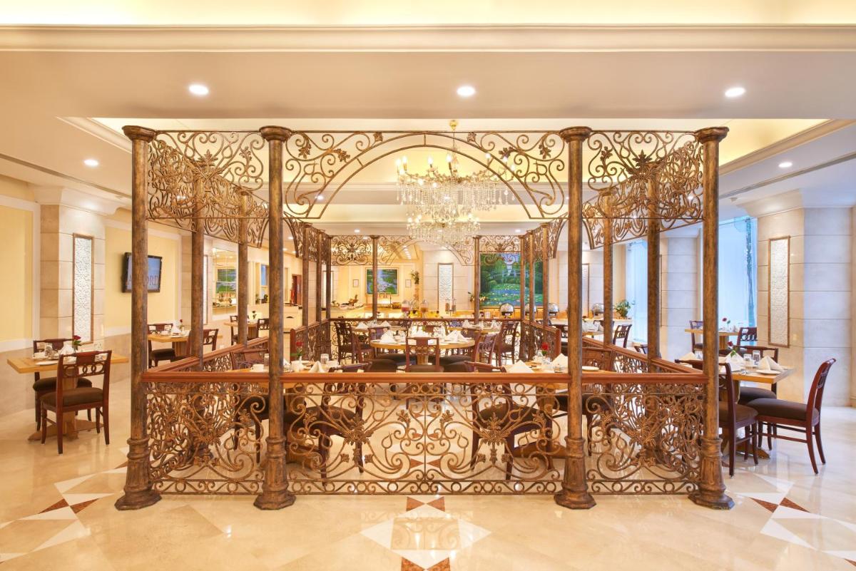 a dining room with a large iron gate at Accord Puducherry in Puducherry