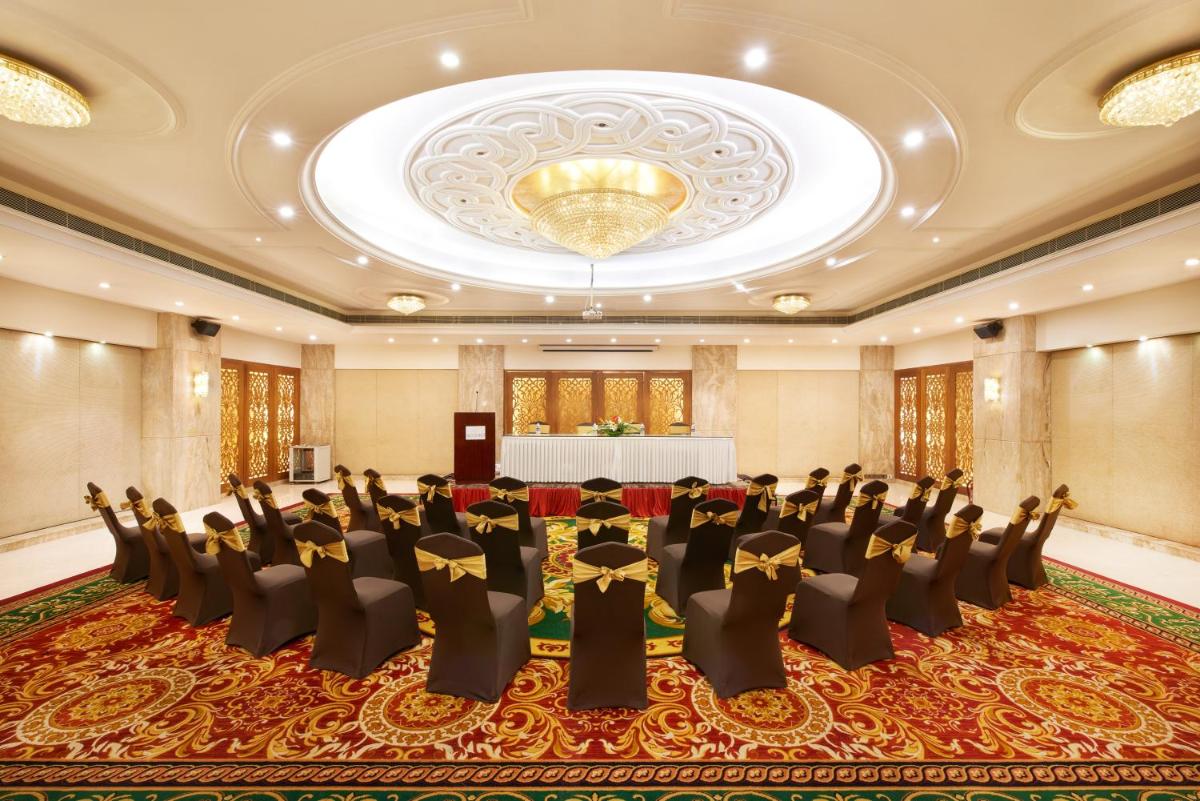 a large banquet hall with chairs and a table at Accord Puducherry in Puducherry