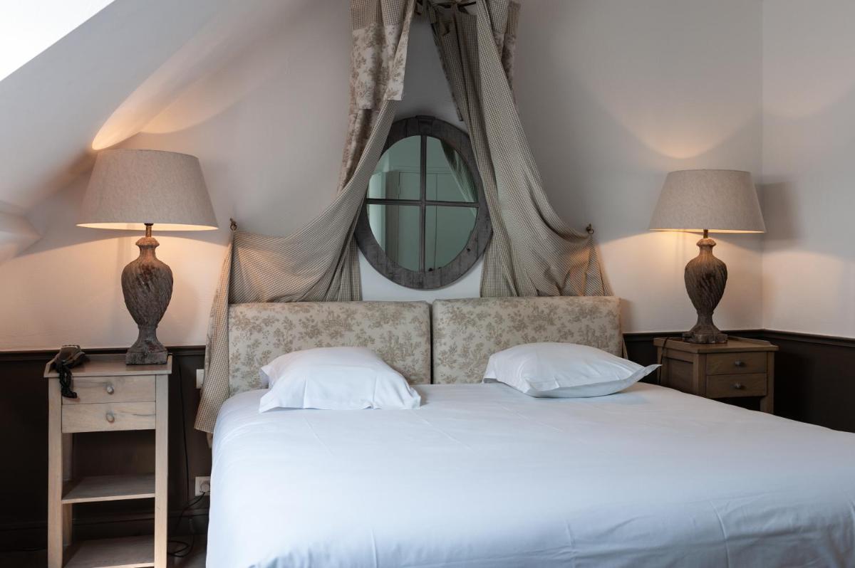 Un ou plusieurs lits dans un hébergement de l'établissement Château de Courban and Spa Nuxe