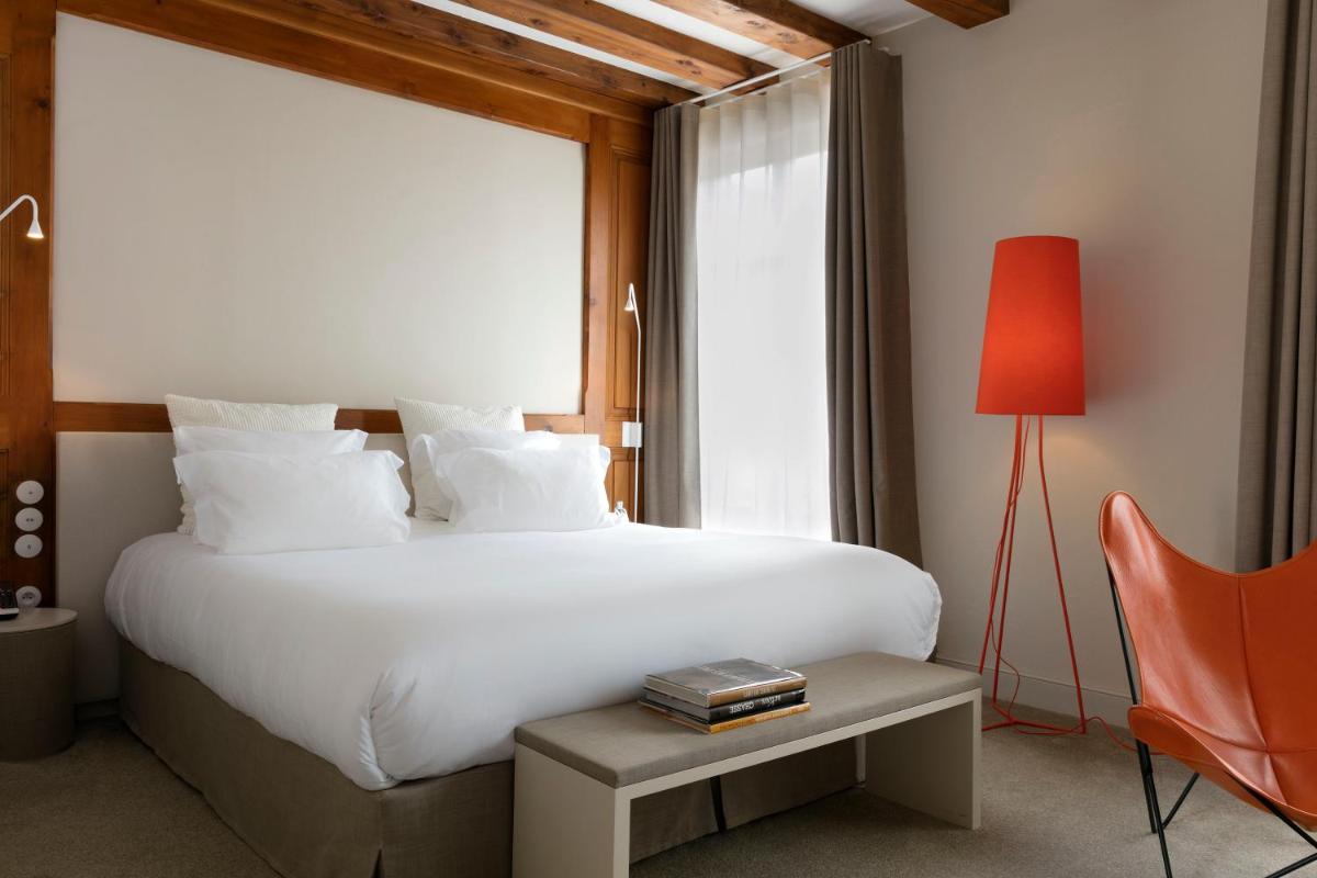 Un ou plusieurs lits dans un hébergement de l'établissement Relais & Châteaux La Maison Des Têtes