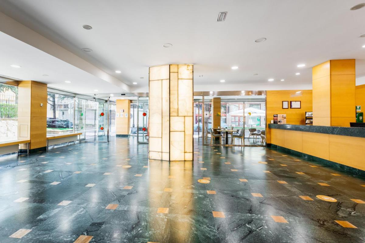 un vestíbulo vacío de un edificio con columnas amarillas en Oroel Hotel & SPA, en Jaca 96 fotos más