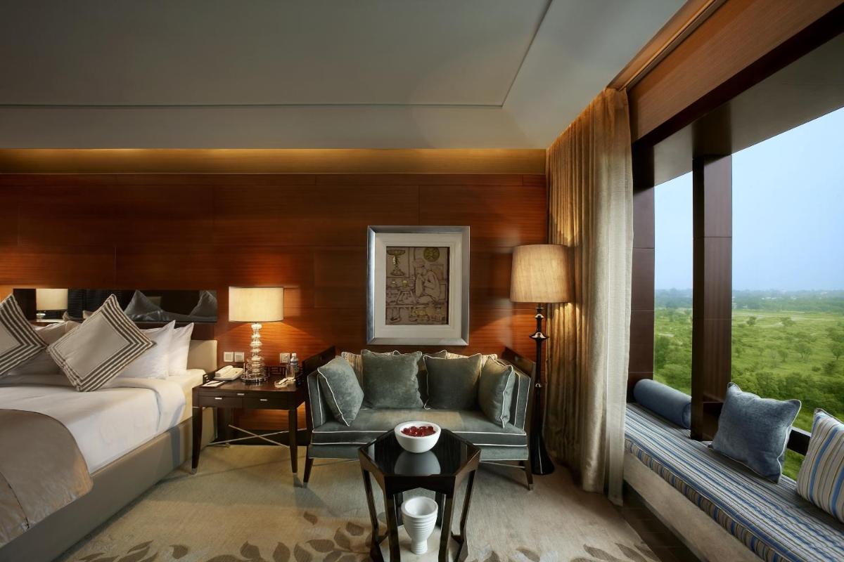 a hotel room with a bed and a couch at The Leela Ambience Gurugram Hotel & Residences - The Luxury Urban Sanctuary in Gurgaon