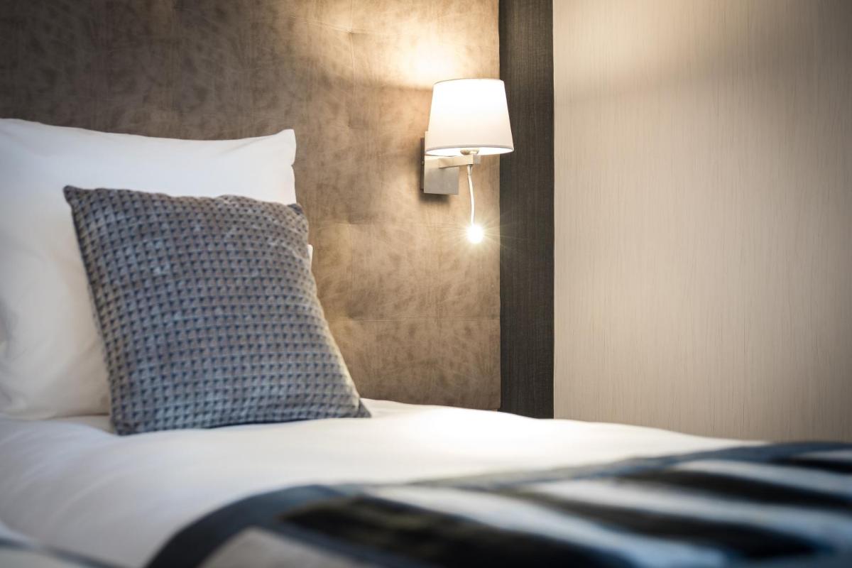 Un ou plusieurs lits dans un hébergement de l'établissement Hôtel Le Rive Droite & SPA