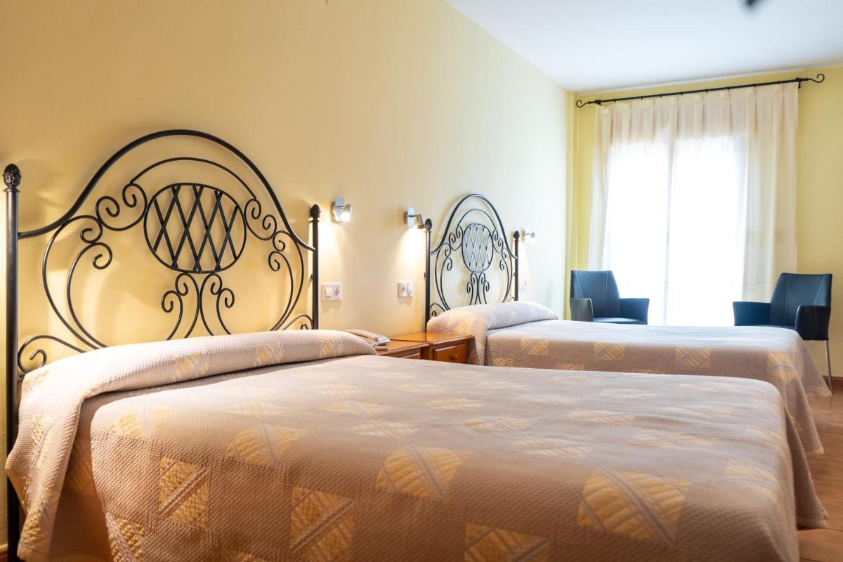 Cama o camas de una habitación en Hotel Castellote