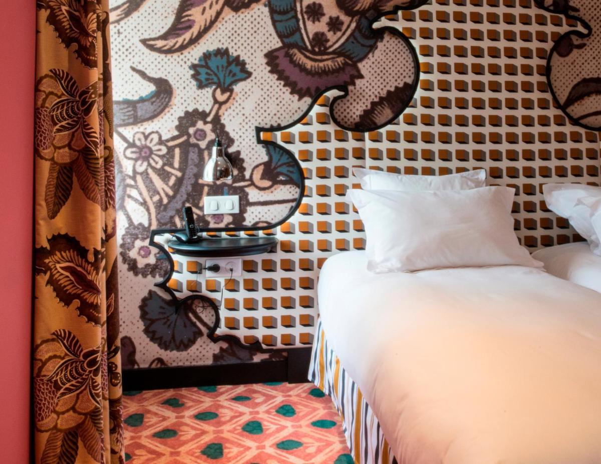 Un ou plusieurs lits dans un hébergement de l'établissement Jules César Hotel & Spa Arles - MGallery Collection