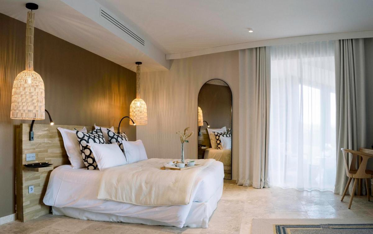 Un ou plusieurs lits dans un hébergement de l'établissement Château L'Hospitalet Wine Resort Beach & Spa