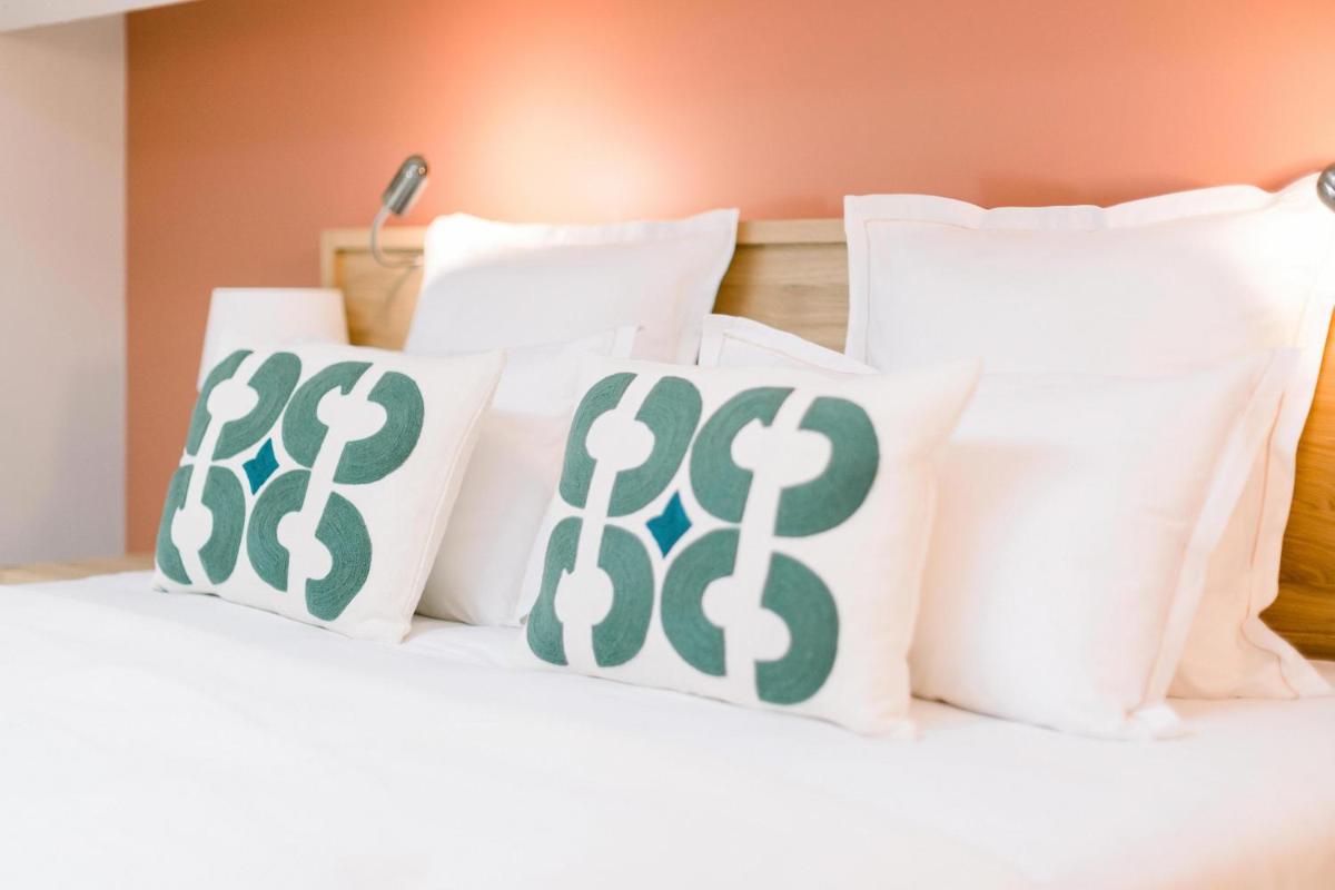 Un ou plusieurs lits dans un hébergement de l'établissement Château L'Hospitalet Wine Resort Beach & Spa