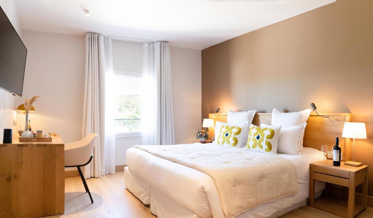 Un ou plusieurs lits dans un hébergement de l'établissement Château L'Hospitalet Wine Resort Beach & Spa