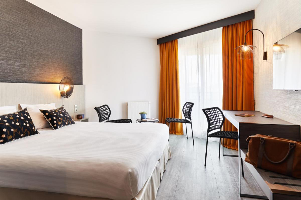 Un ou plusieurs lits dans un hébergement de l'établissement Hôtel Valdys Thalasso & Spa - les Pins