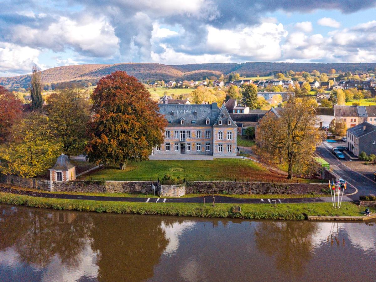 - une vue aérienne sur une grande maison à côté d'un lac dans l'établissement Chateau de Wallerand, à Vireux-Wallerand