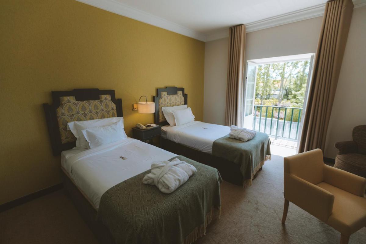 Uma cama ou camas num quarto em Conimbriga Hotel do Paço