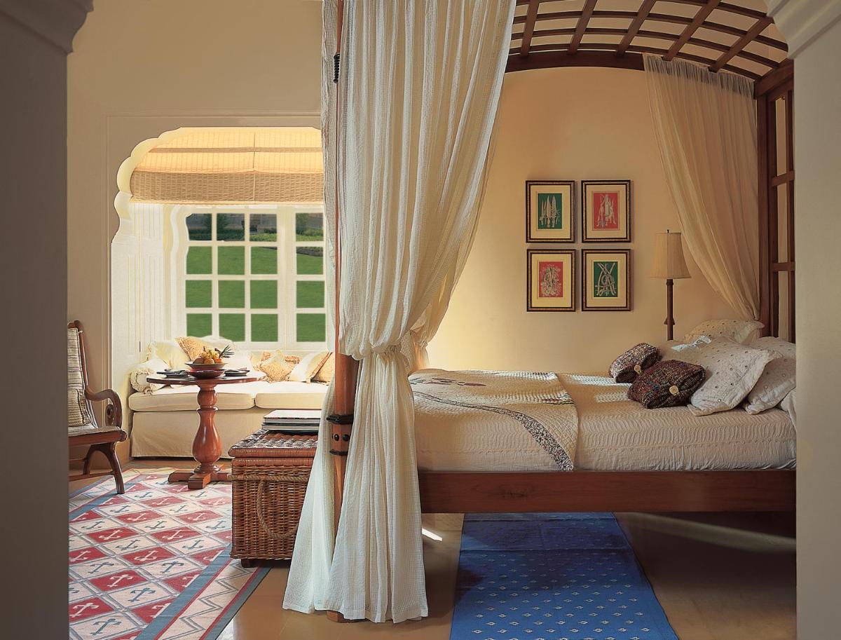 a bedroom with a canopy bed and a window at The Oberoi Rajvilas Jaipur in Jaipur