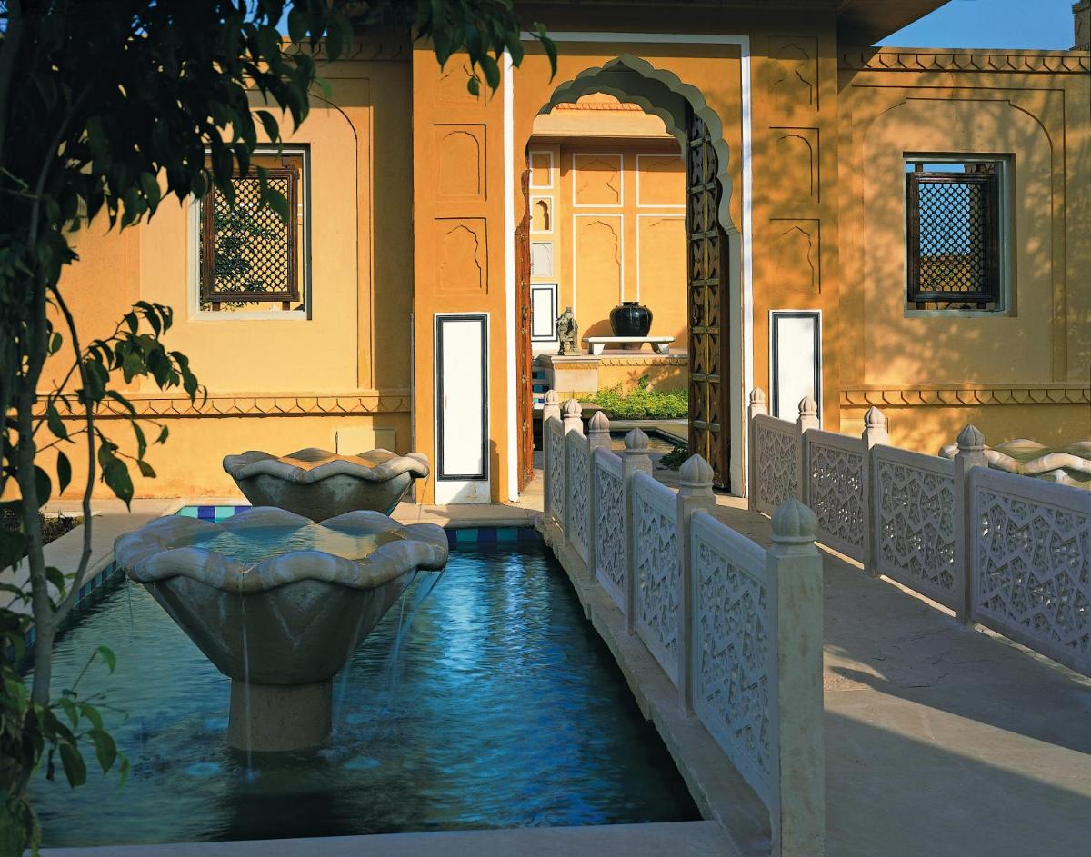 a pool of water in the courtyard of a building at The Oberoi Rajvilas Jaipur in Jaipur