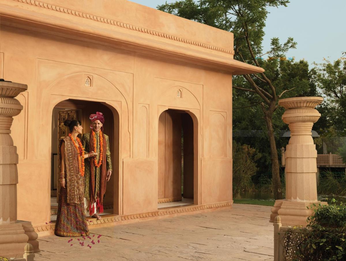 two women standing in the doorway of a building at The Oberoi Rajvilas Jaipur in Jaipur