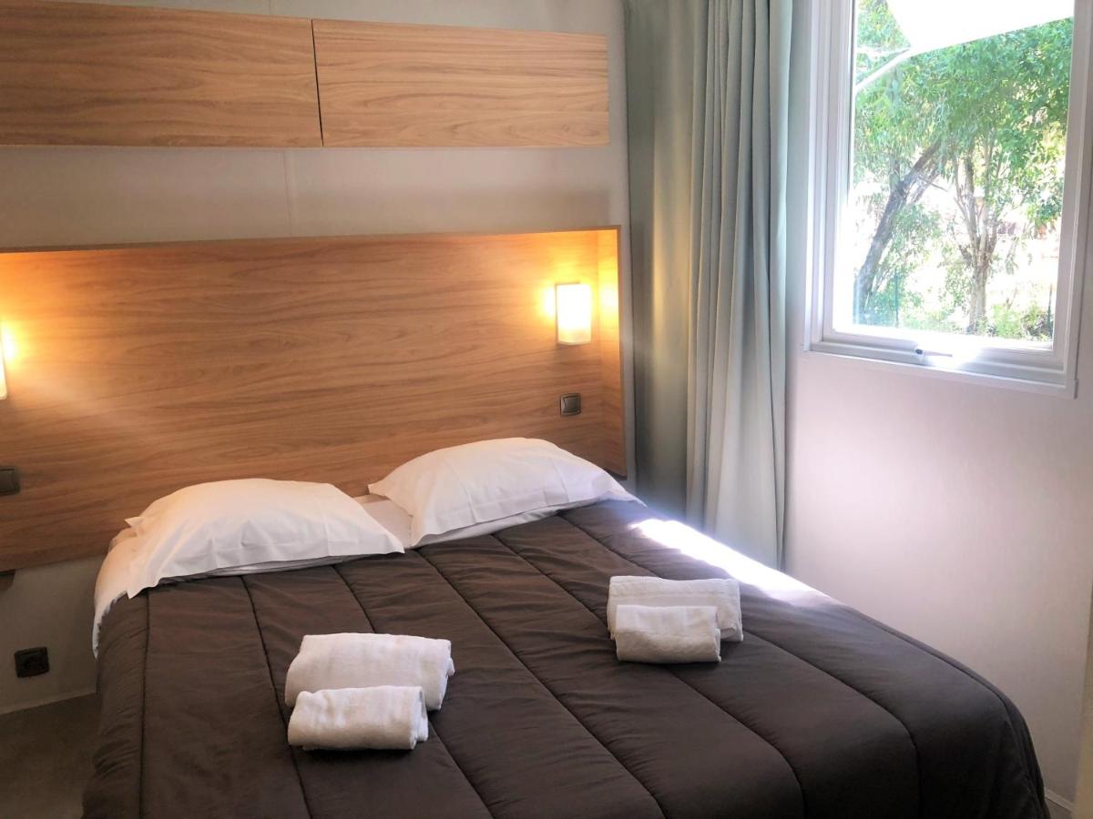 Un ou plusieurs lits dans un hébergement de l'établissement Camping La Pinède
