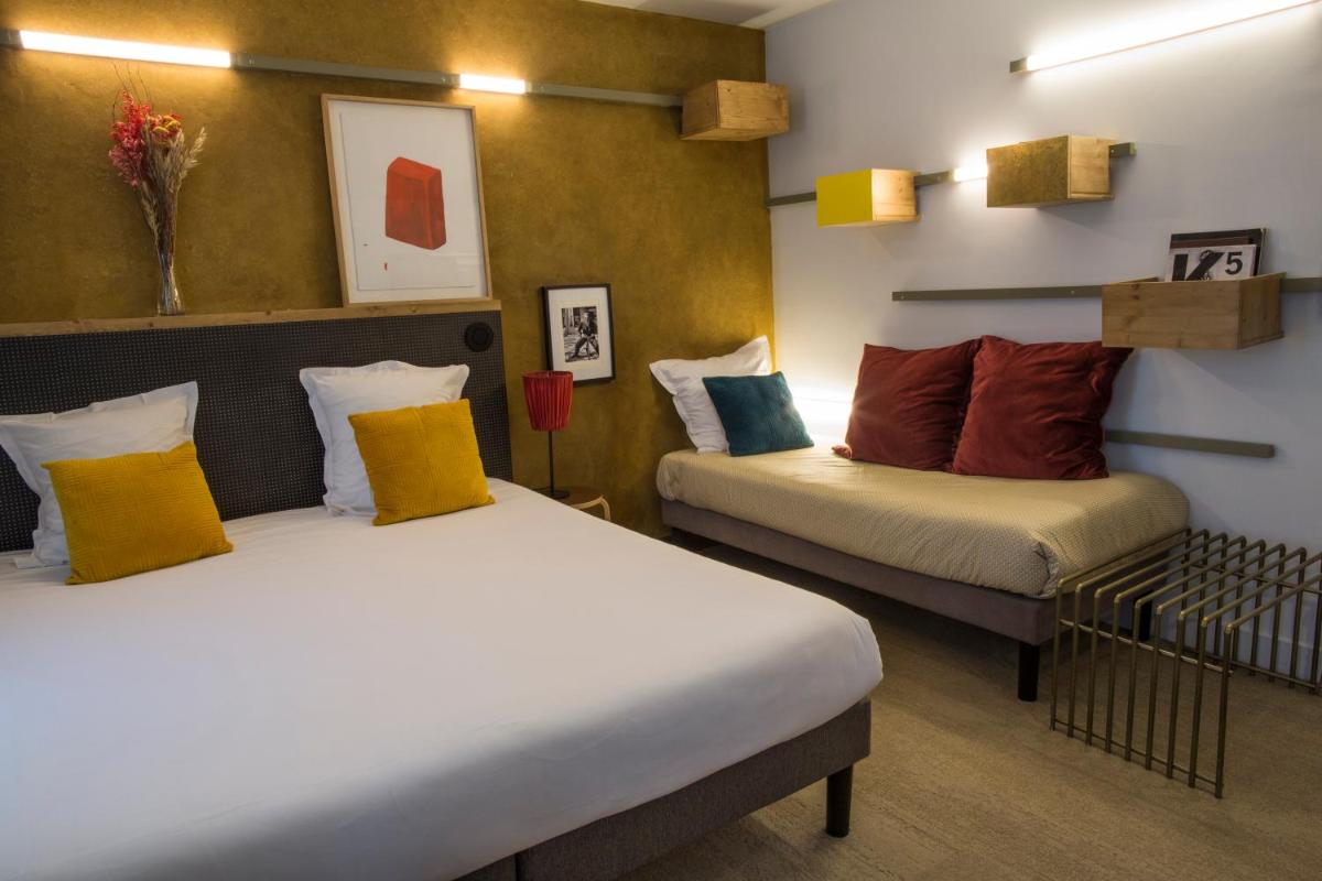 Un ou plusieurs lits dans un hébergement de l'établissement Hôtel La Nouvelle République & Hammam