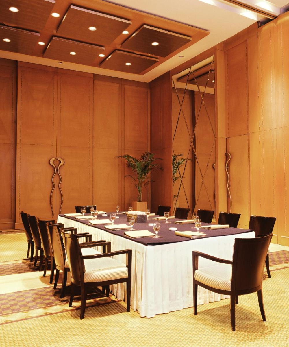 a large conference room with a long table and chairs at Trident Gurgaon in Gurgaon