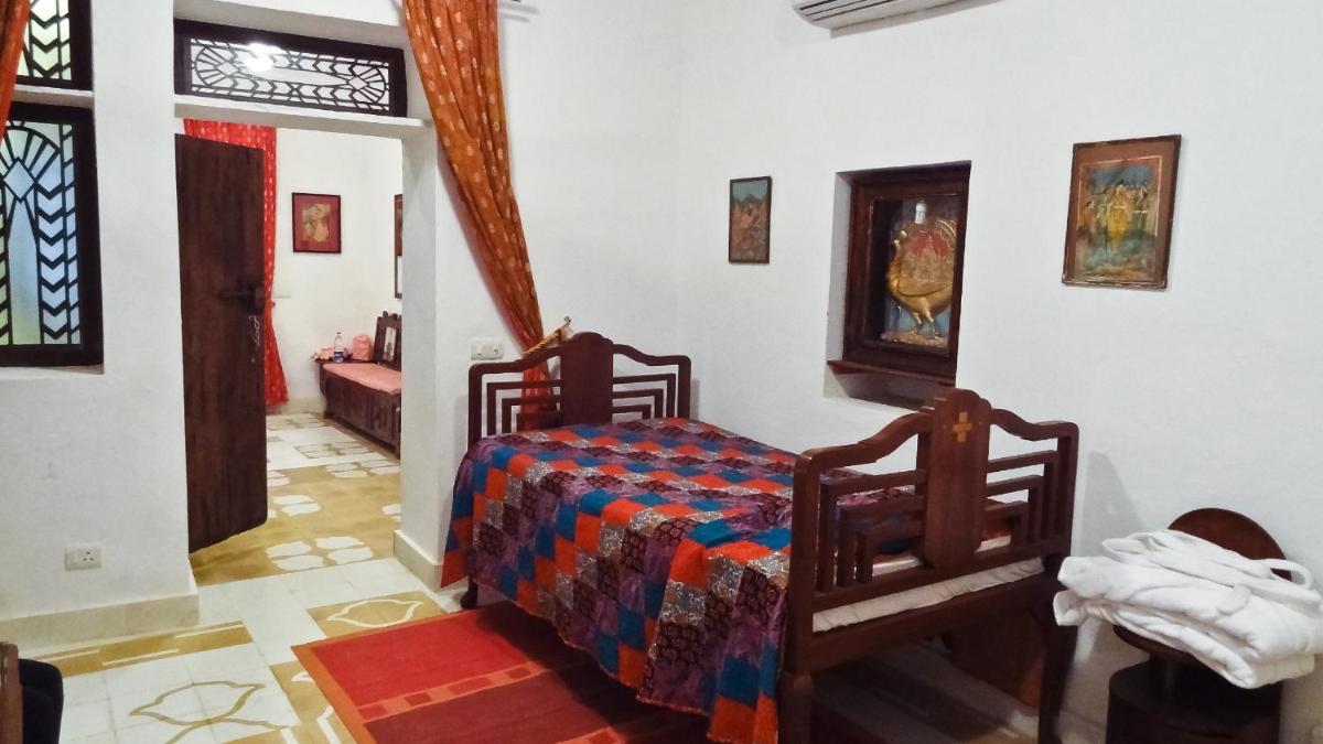 a bedroom with a bed in a room at Neemrana Fort-Palace in Neemrana