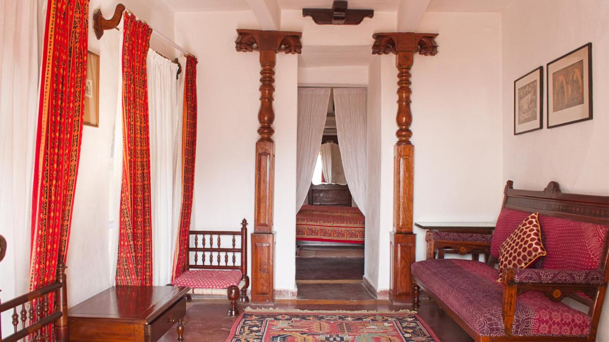 a living room with a couch and a bed at Neemrana Fort-Palace in Neemrana