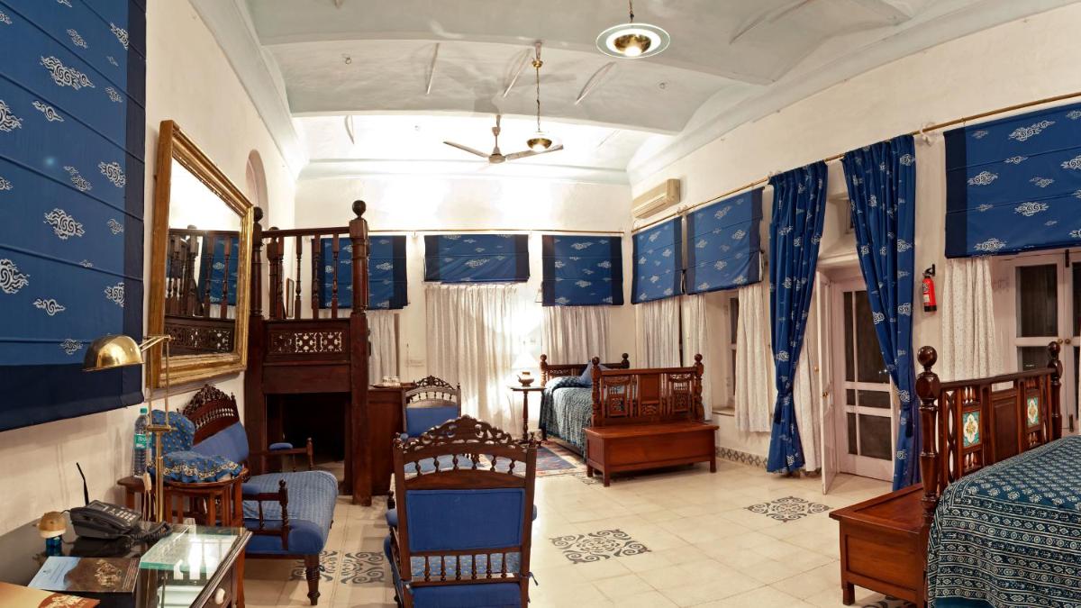 a bedroom with blue and white walls and a bed at Neemrana Fort-Palace in Neemrana