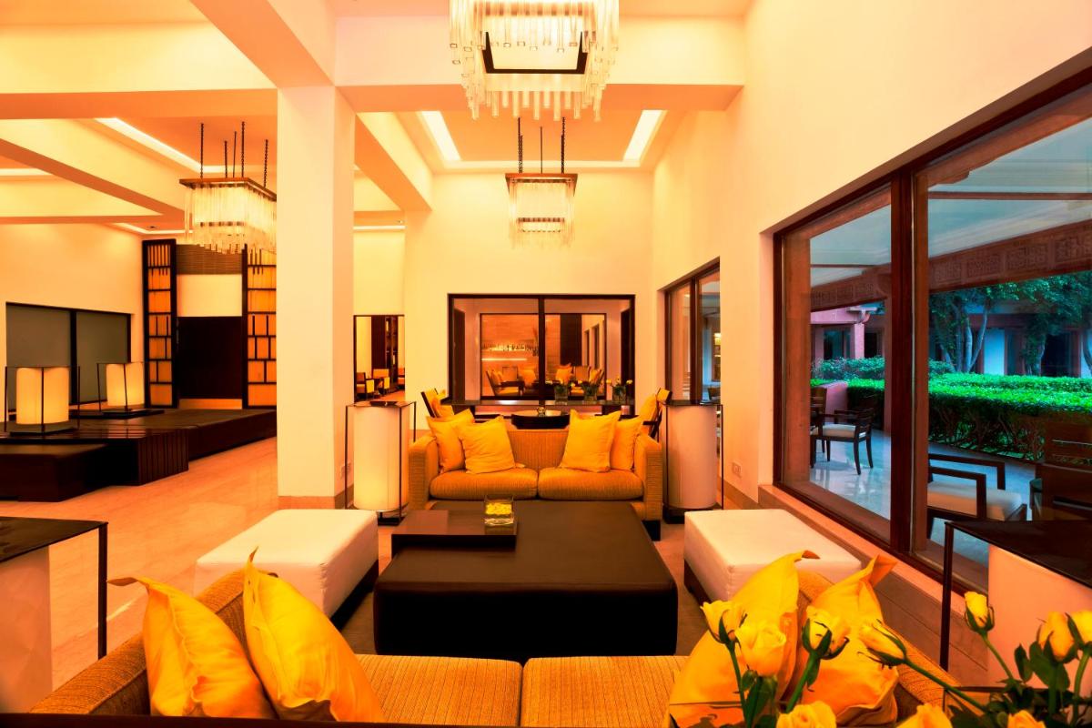 a living room with yellow pillows and a couch at Trident Agra in Agra