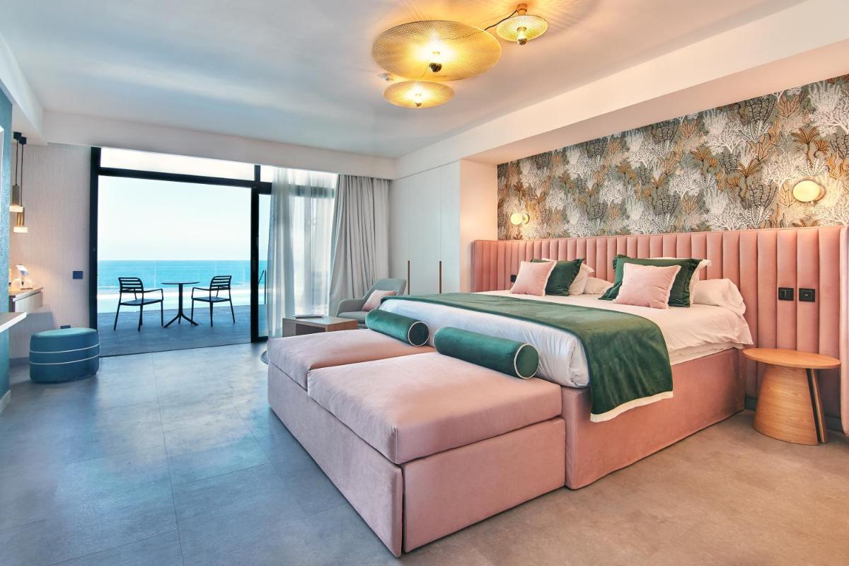 Un dormitorio con una cama grande y un sofá. en Gloria Palace Amadores Thalasso & Hotel, en Puerto Rico de Gran Canaria