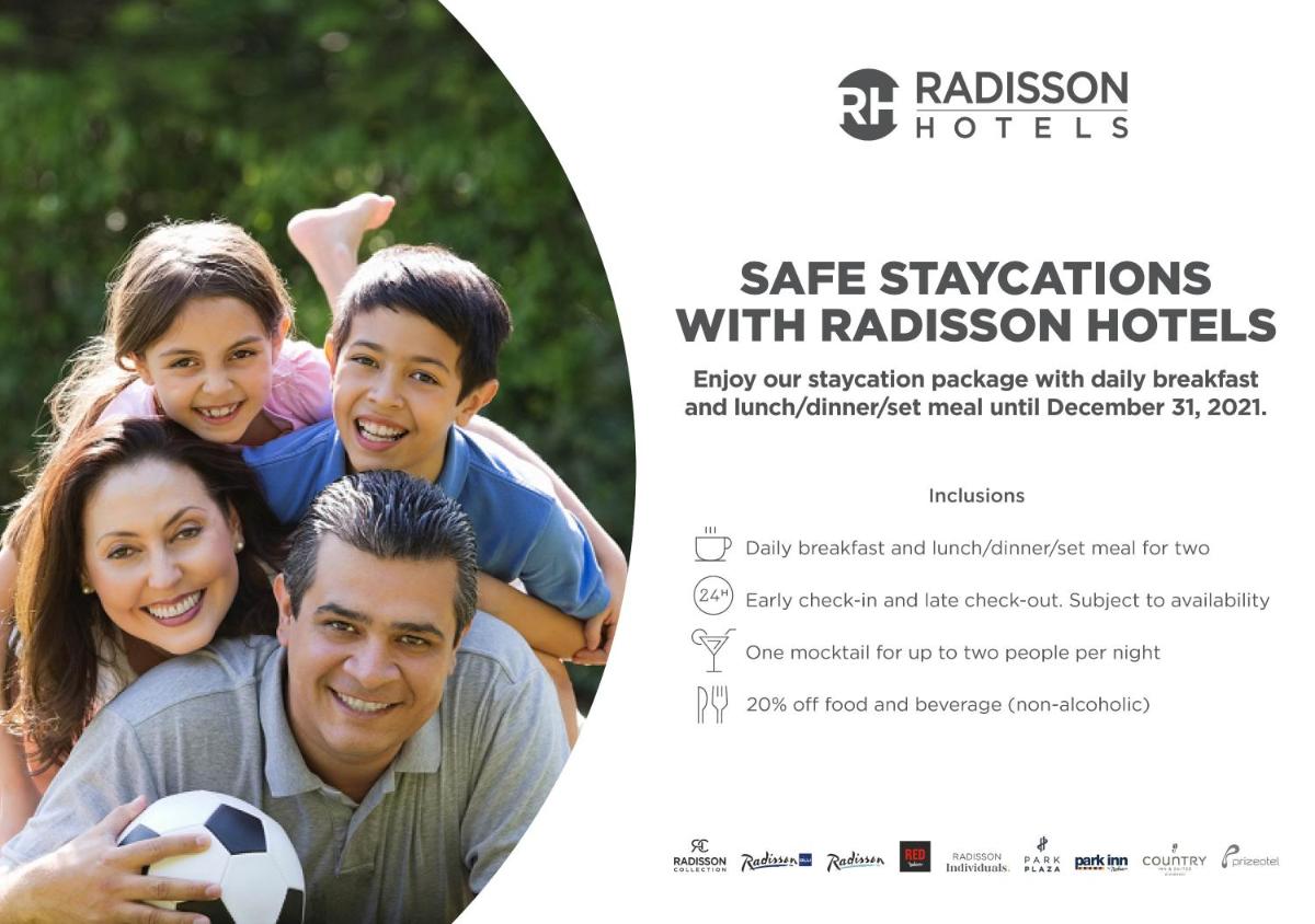 a poster of a family with a soccer ball at Radisson Blu Hotel, Indore in Indore